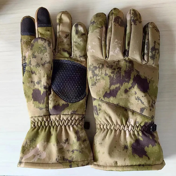 A pair of camouflage nylon ski gloves with touch screen fingertips on a winter background.