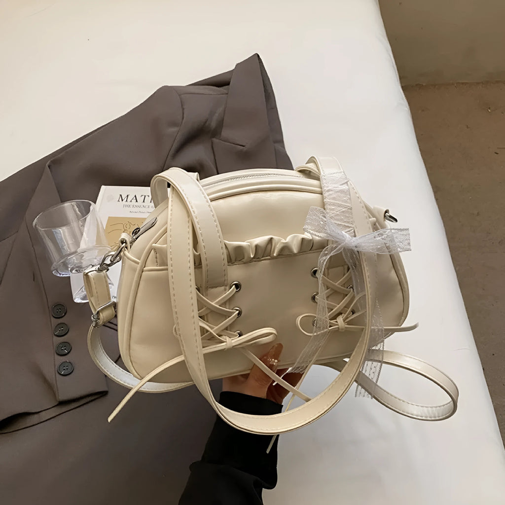 Women's casual PU leather handbag with a bandage bow decoration on the front.