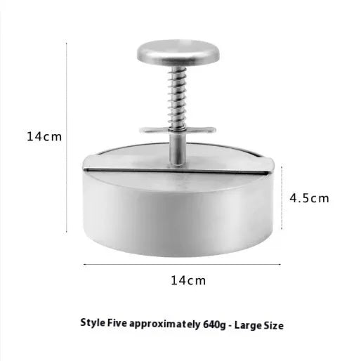Silver stainless steel patty mould with 14cm diameter on a kitchen counter