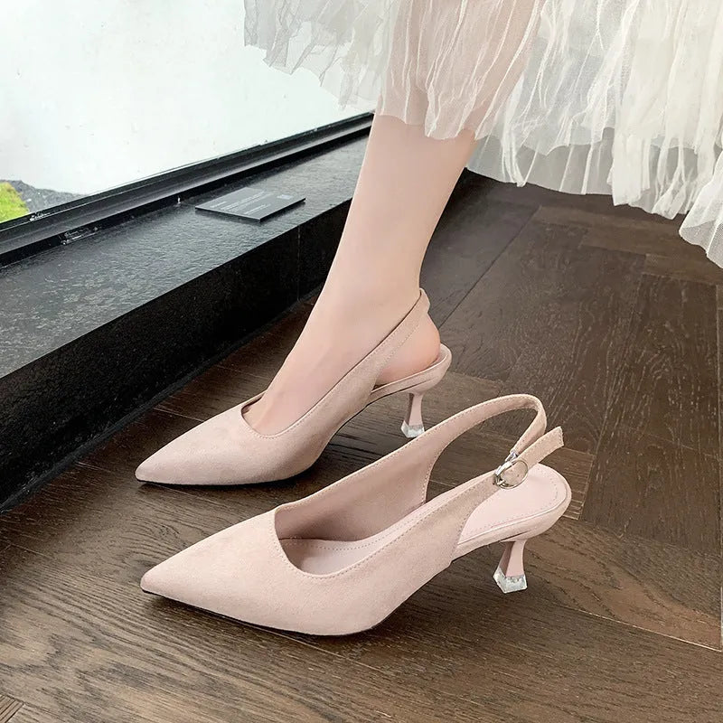 Women's pink suede pointed-toe stiletto high heels on a plain background