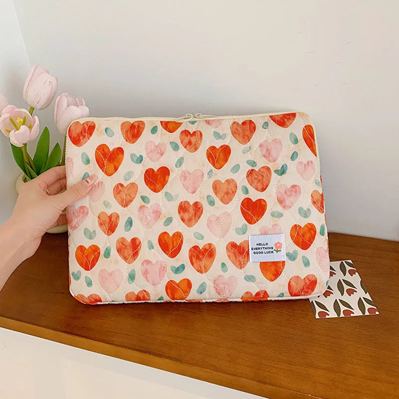 Green floral print cloth laptop bag showing front storage pocket and slim 3cm depth profile.