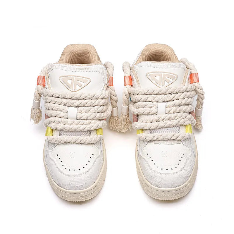 Creamy white low-top retro skate shoes with platform heel and lace-up design on a plain background.