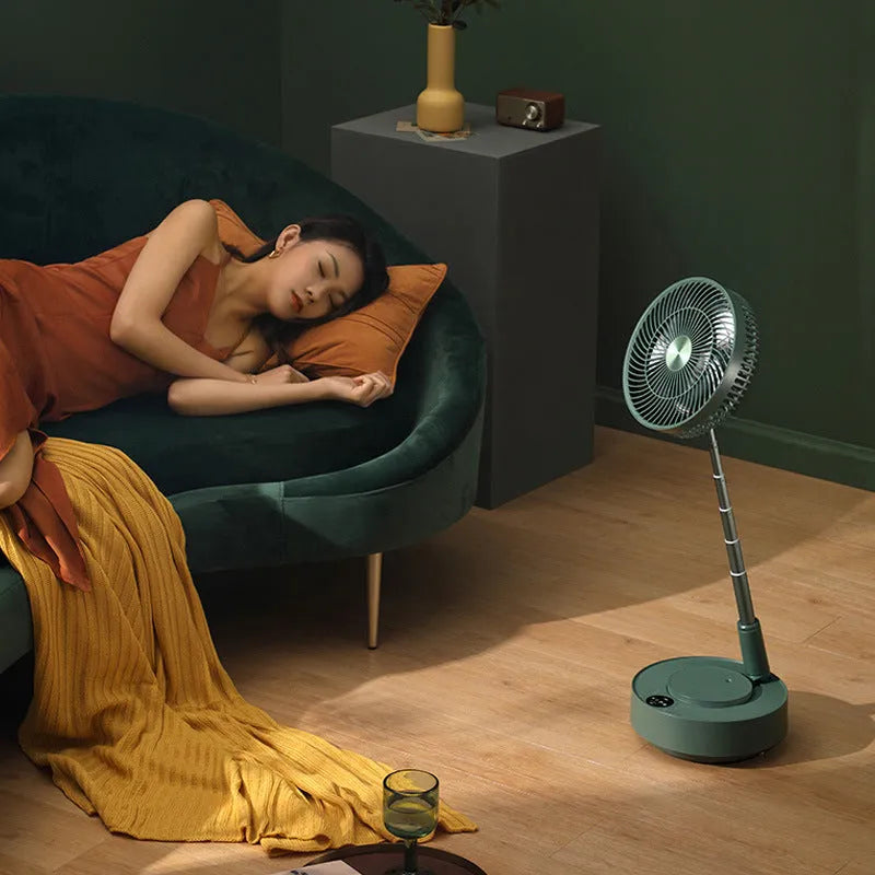 Green telescopic rechargeable floor fan extended to full height with remote control