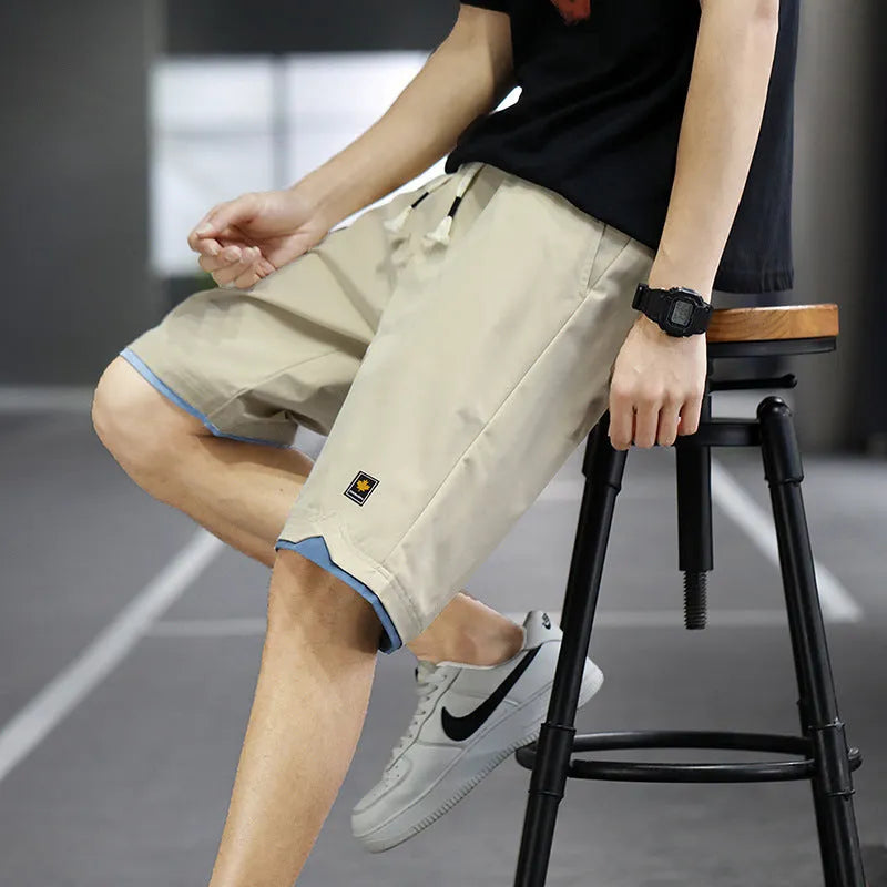 Loose straight-leg polyester beach shorts with elastic waist in multiple colour options