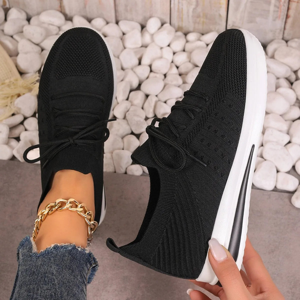 Women's red fly-knit casual sneakers with round toe and lace-up front on a white background