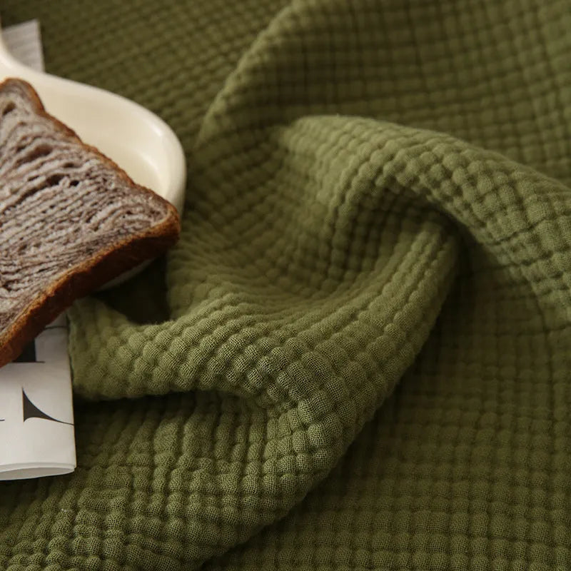 Four-layer gauze cotton blanket with tassel trim in avocado green colour