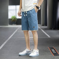Loose straight-leg polyester beach shorts with elastic waist in multiple colour options