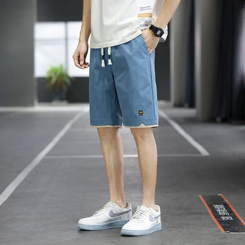 Loose straight-leg polyester beach shorts with elastic waist in multiple colour options