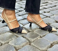 Women's apricot and black colour block pointed toe stiletto sandals with a buckle strap.