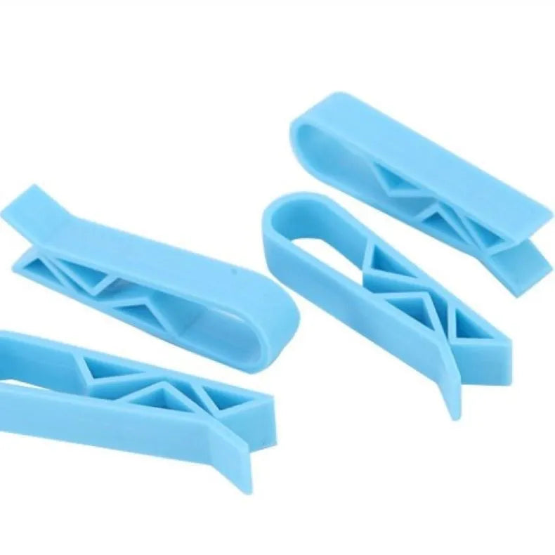 White PP plastic garbage bag fixing clip attached to the rim of a black indoor bin.
