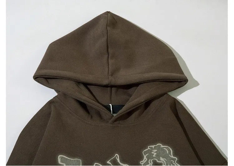 Loose-fitting couples oversize hoodie in brown, round neck, long sleeves, side view on plain background