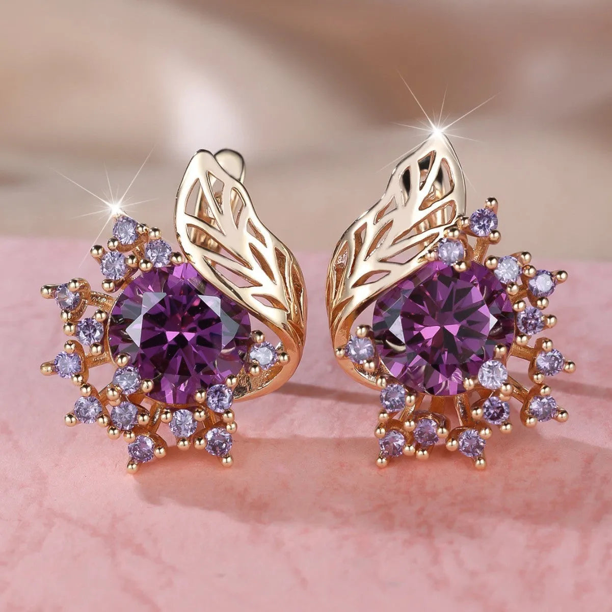 Rose gold coloured feather and flower design earrings with a choice of coloured zircon centre stones.