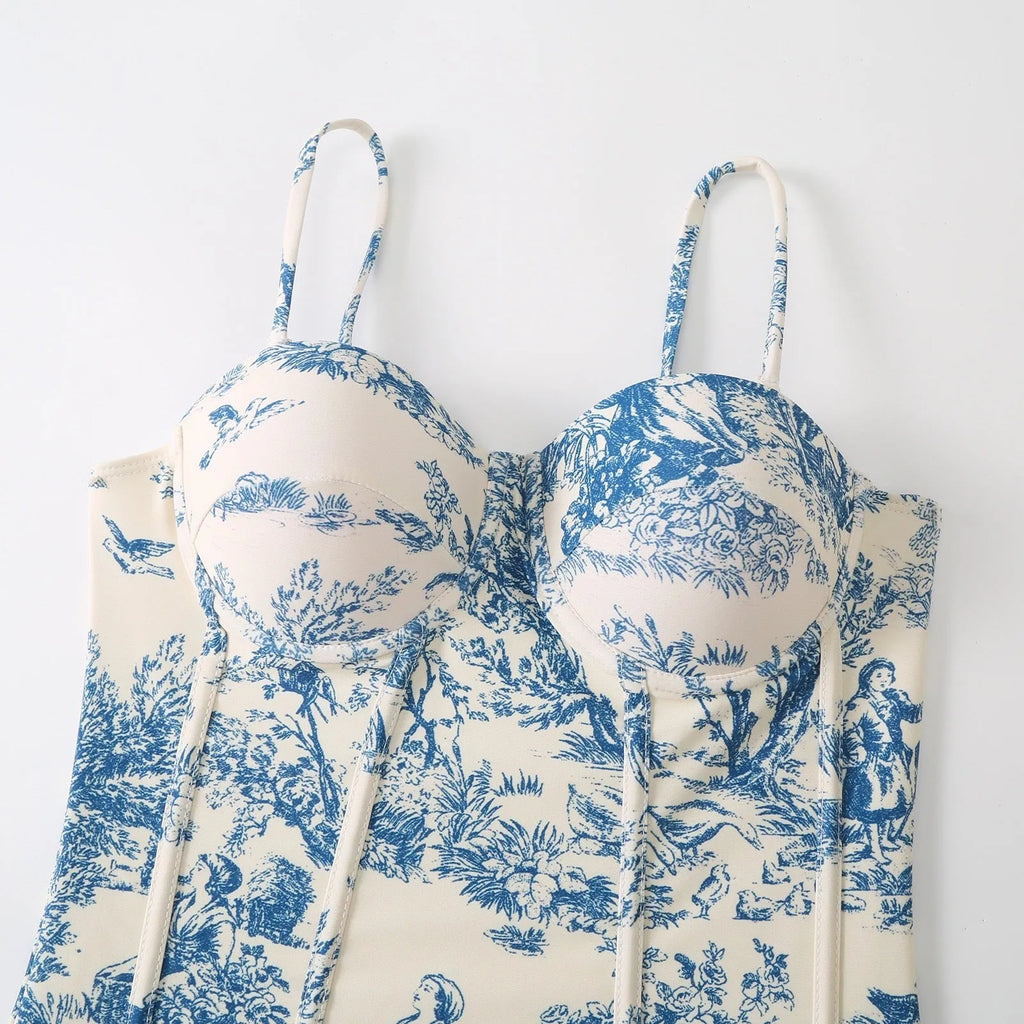 Blue women's one-piece swimsuit with a matching separate gauze skirt laid flat.