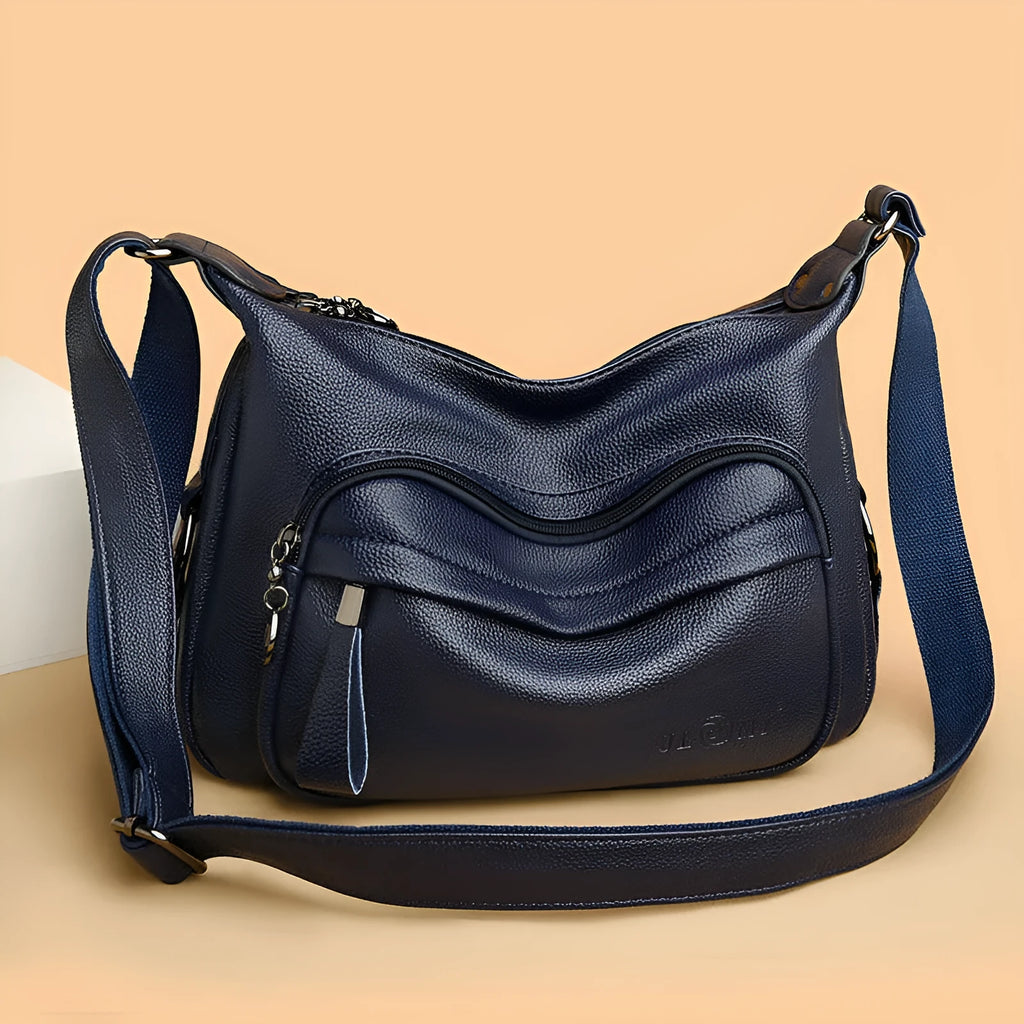 Large black women's shoulder bag with multiple compartments and luggage-inspired styling
