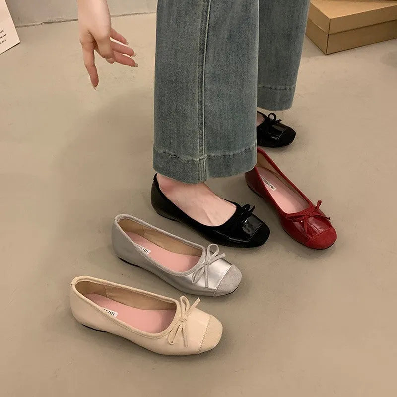 Retro apricot colour Mary Jane ballet flats with bow detail and square toe on a white background.