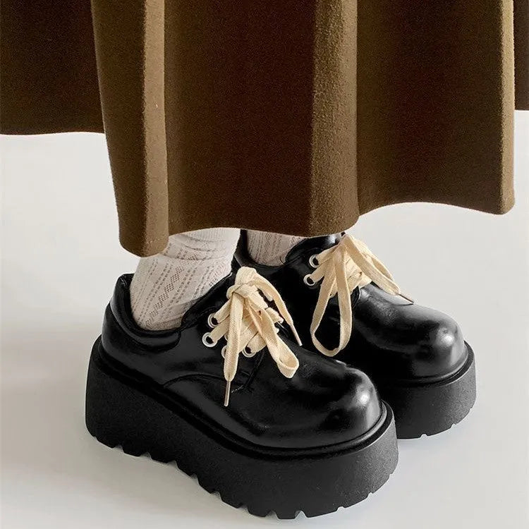 Matte black women's lace-up platform heels with chunky 6-8cm sole and round toe.