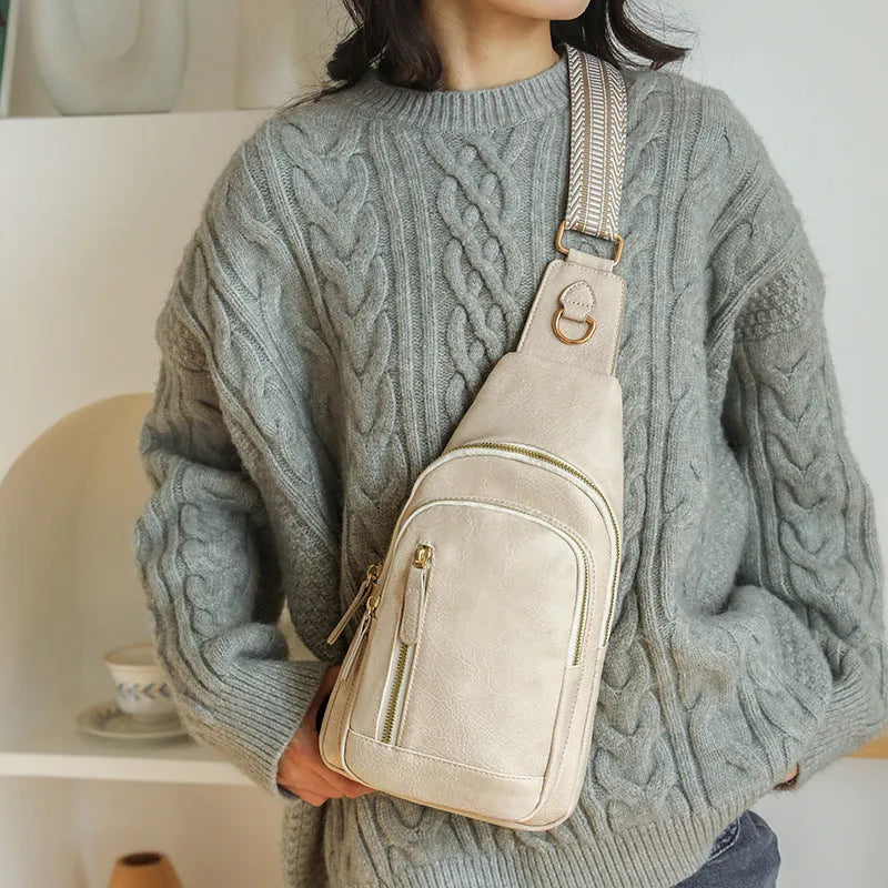 Women's soft brown PU chest bag with crossbody strap and open front pocket.