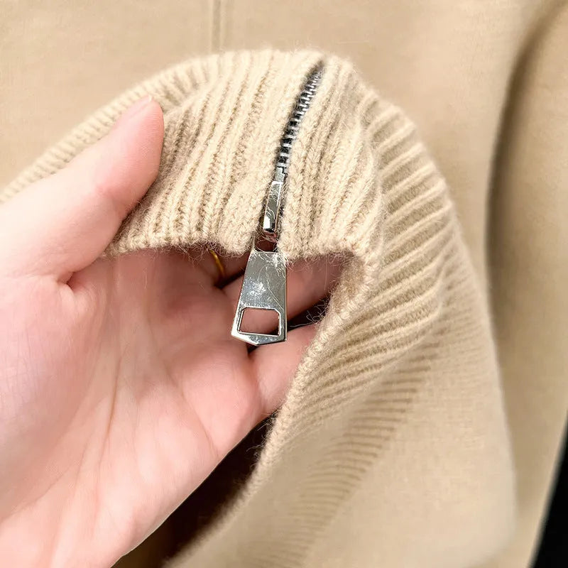 Man wearing a beige stand collar knitted zip cardigan in a loose fit.