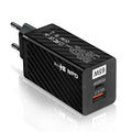 Compact white GaN 65W USB-C laptop charger with EU, UK, and US plug attachments on a table.