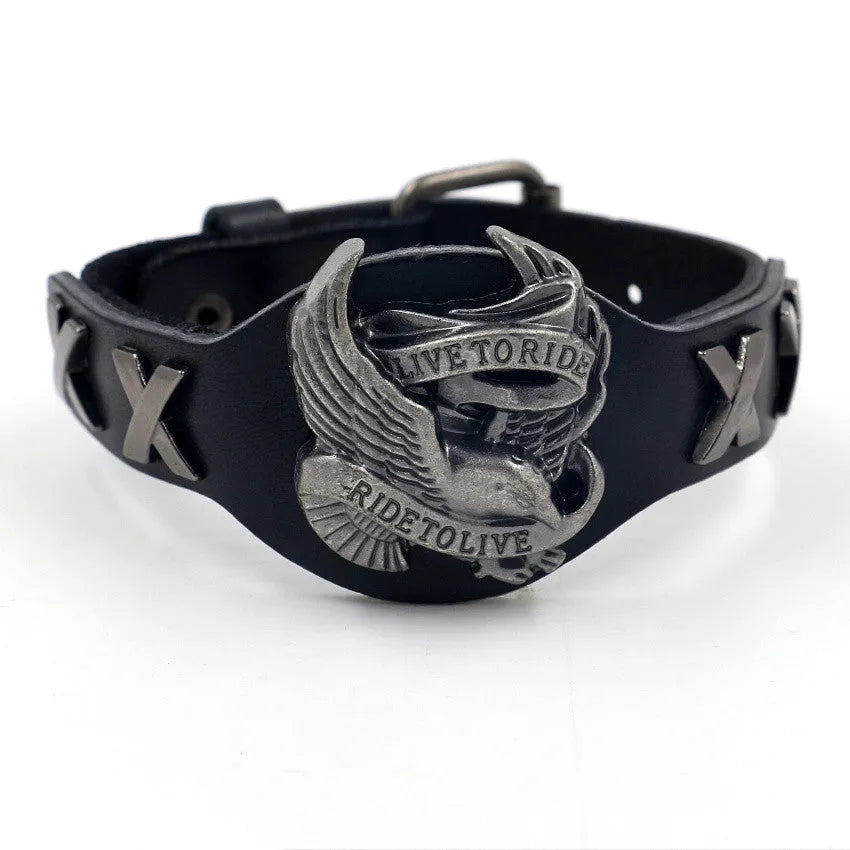 Black geometric leather bracelet with a detailed alloy eagle watch-button clasp on a wrist.