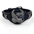 Black geometric leather bracelet with a detailed alloy eagle watch-button clasp on a wrist.