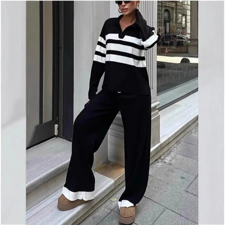 Women's black and white striped knitted polo shirt and trouser two-piece set.