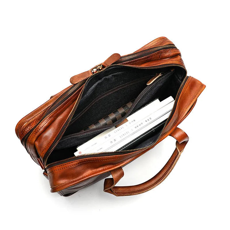 Men's leather briefcase showing multiple interior organisational pockets including laptop compartment
