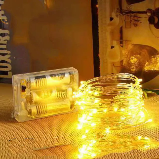 12-metre long copper wire LED string lights with 120 small bulbs, showing yellow, green, blue, and warm white colour options.