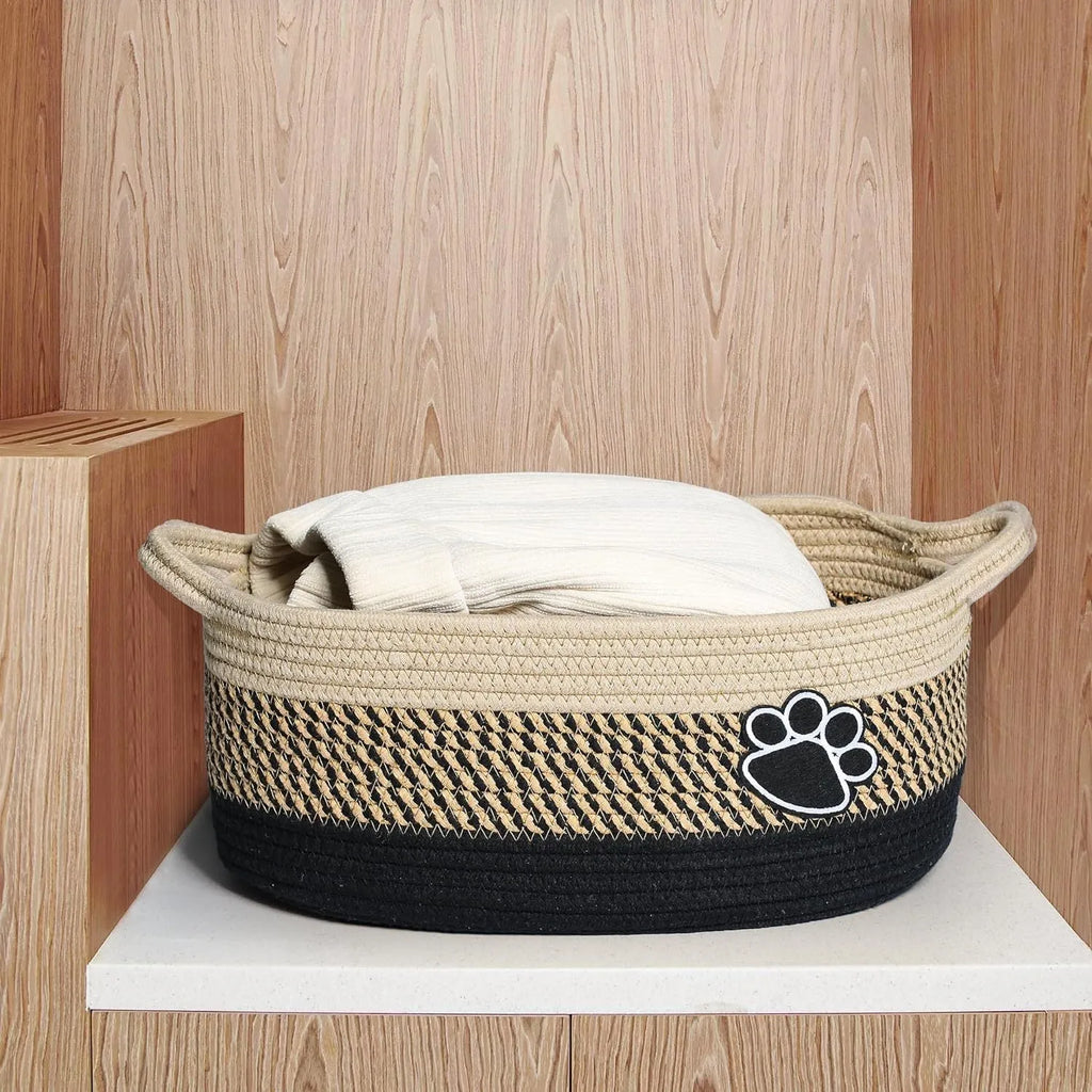 Small light beige handmade cotton rope storage basket with a wooden handle.