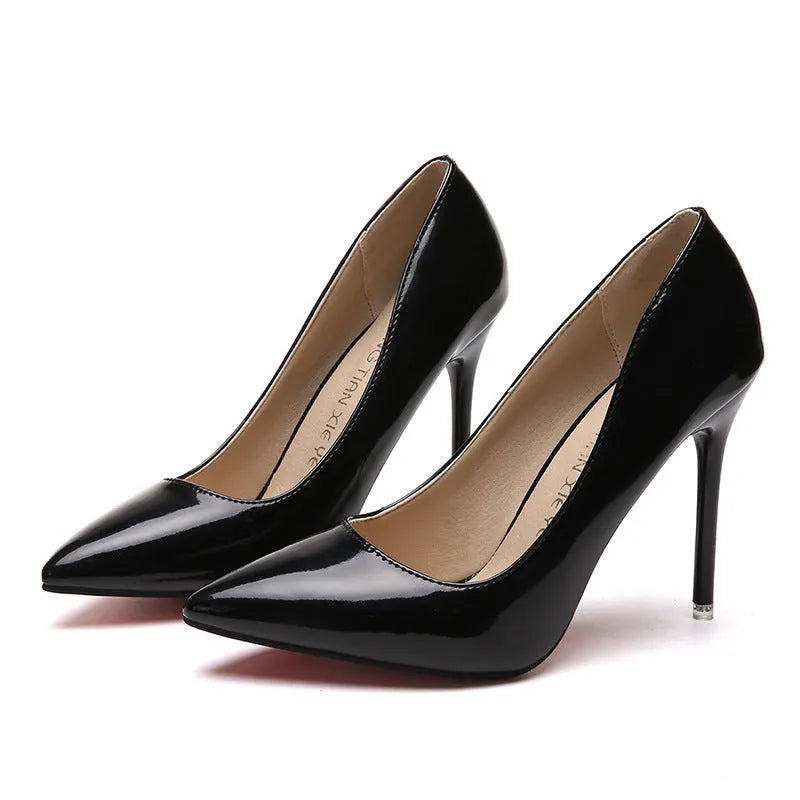 Women's nude apricot stiletto heel pumps with pointed toe and buckle detail on a chunky heel.