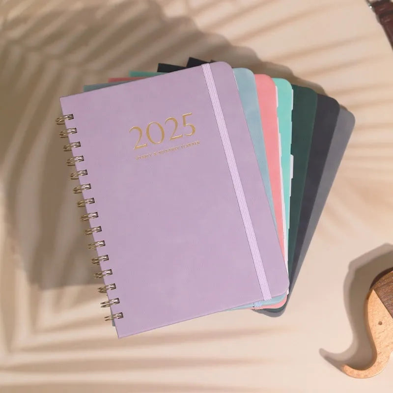 A5 leather notebook with metal coil binding in multiple colour options including black, blue, brown and green.