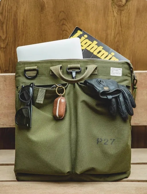 Medium nylon canvas messenger bag in military green with crossbody strap and laptop compartment