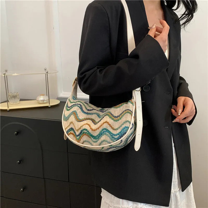 Women's woven straw crossbody bag showing internal phone compartment and file pocket in milky white colour