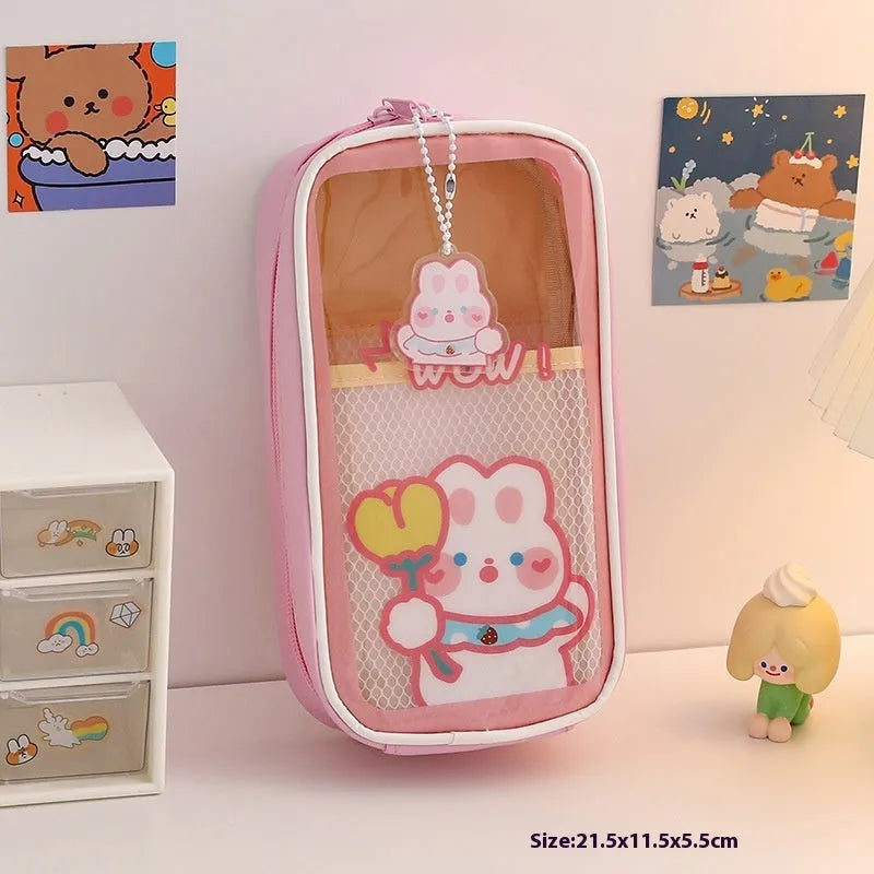 Transparent PVC pencil case with cartoon design showing large capacity interior and zipper closure