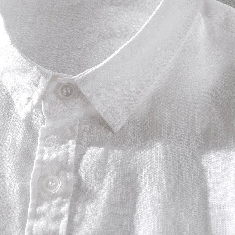 Man wearing a loose-fit short sleeve linen shirt in a solid colour.