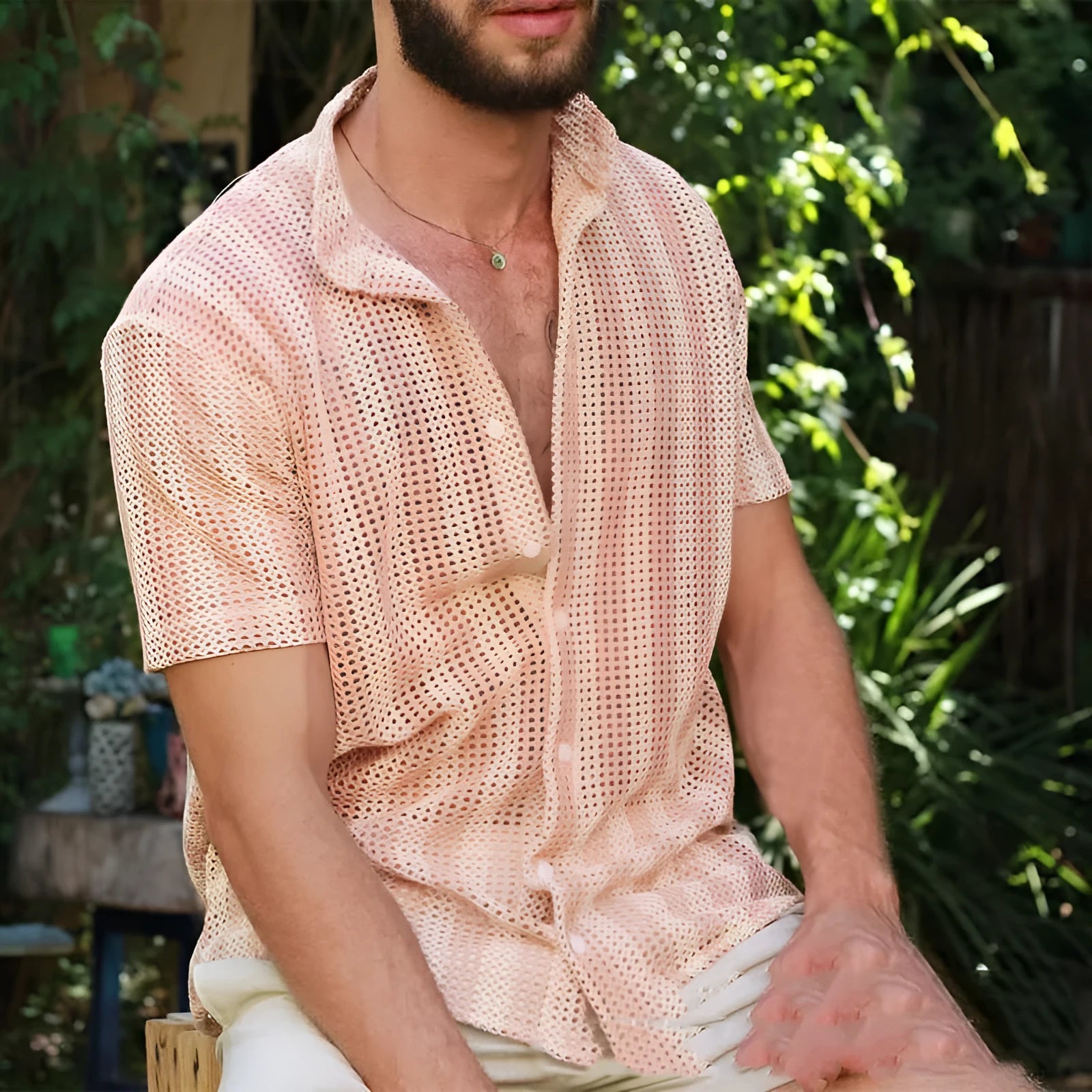 Pink men's short-sleeve cardigan shirt with a waffle-knit texture on a hanger.