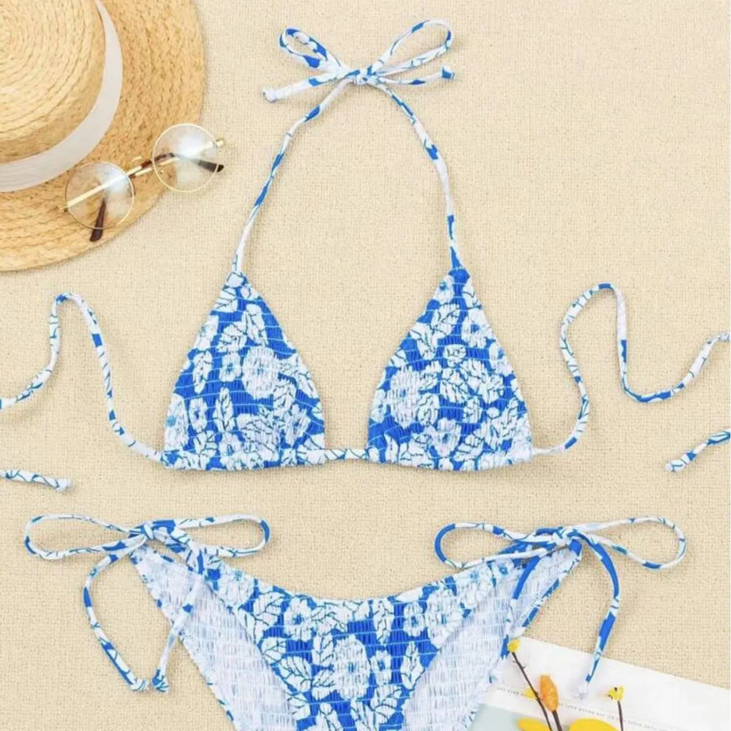 Women's floral halter neck two-piece swimsuit in light blue on a mannequin.