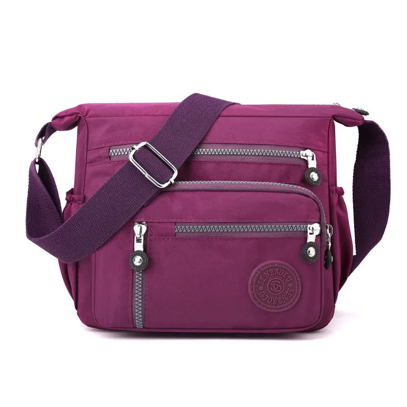 Nylon soft shoulder messenger bag in square vertical shape with single strap.