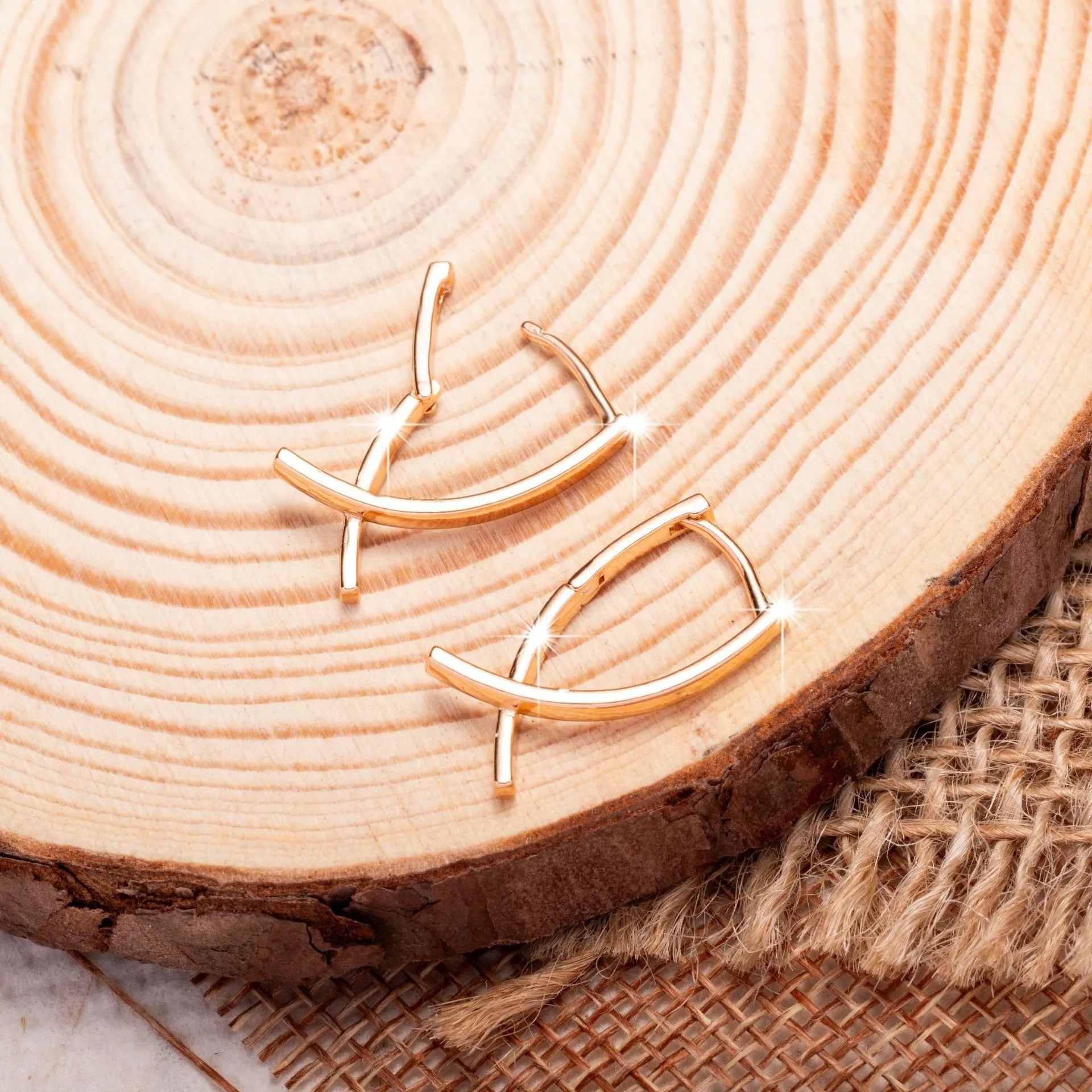 Single pair of rose gold cross shaped earrings made from copper with light luxury design