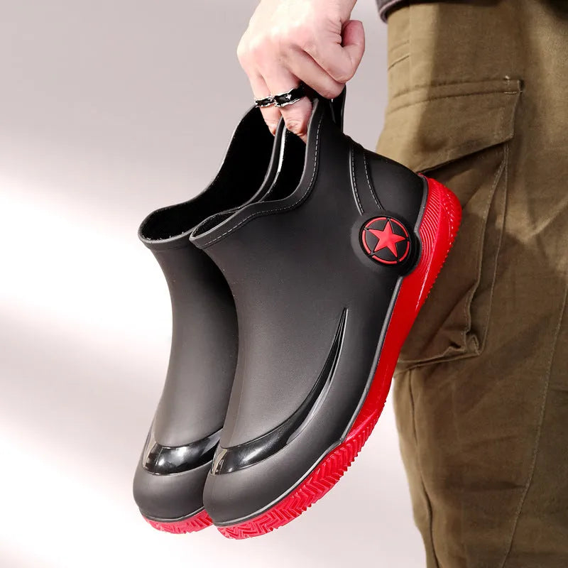 Unisex low-cut PVC rain boots in black with round toe and moulded plastic sole