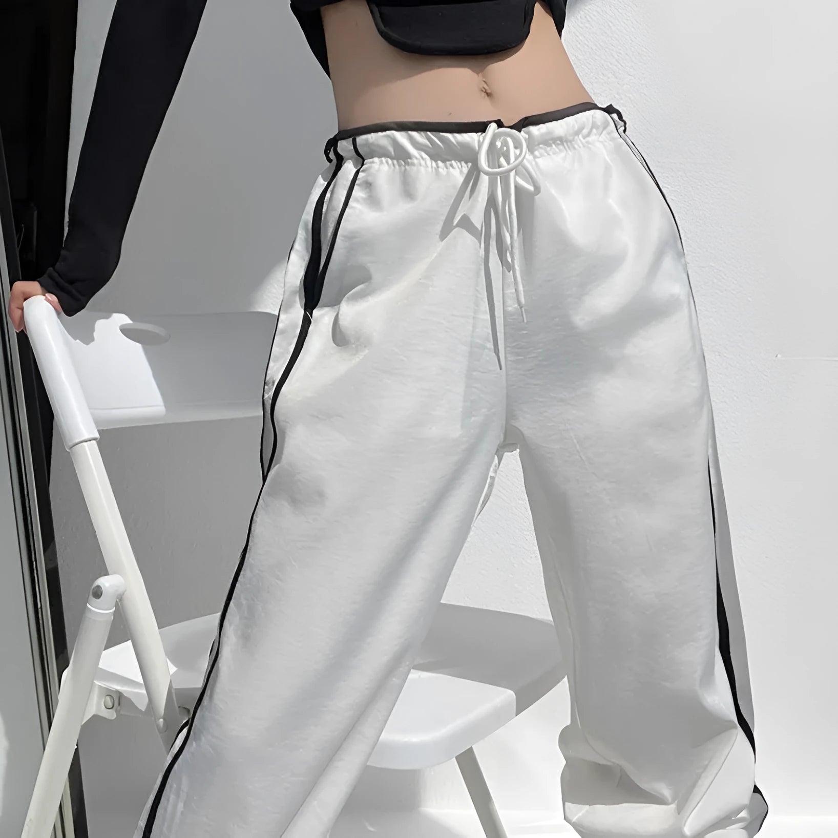 Navy blue loose straight leg drape pants with a low waist and thin fabric, laid flat.