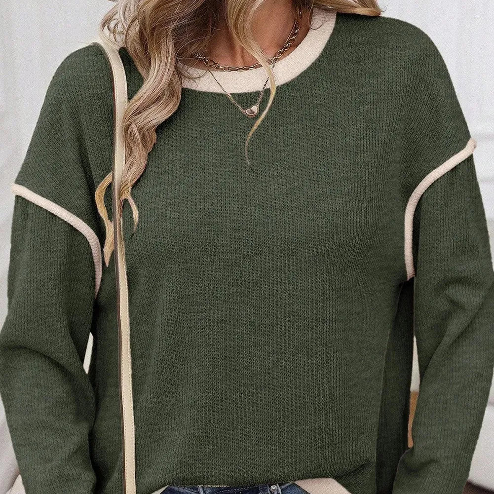 Loose fit beige knitted top with drop shoulders and contrast trim on a hanger.
