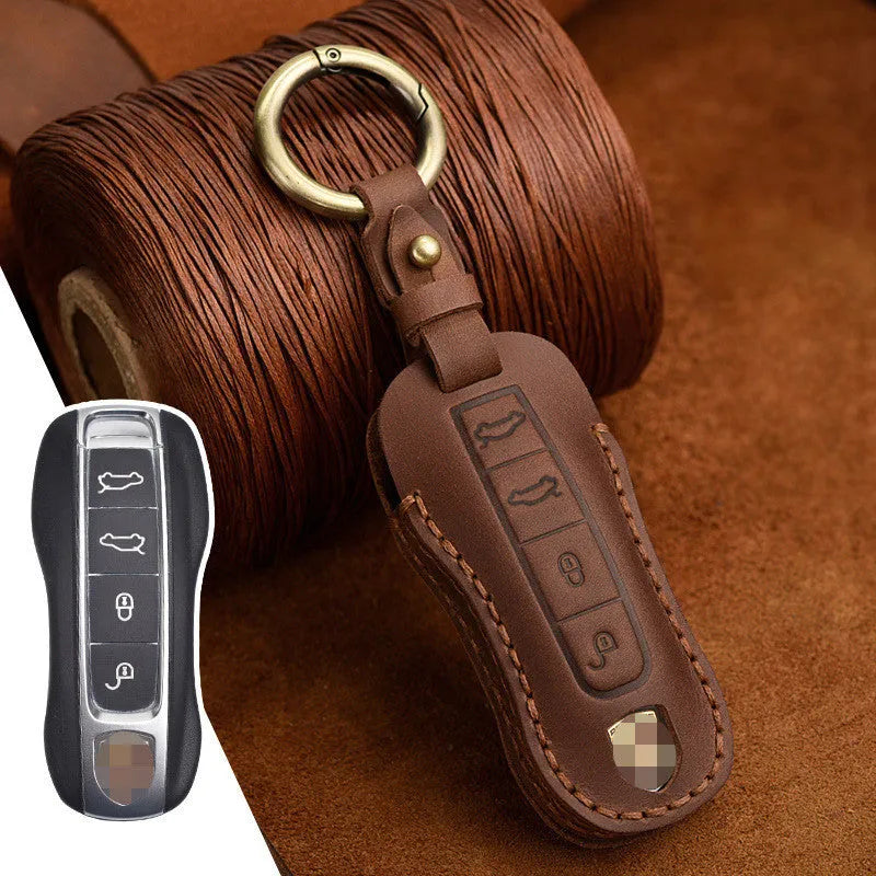 Brown leather Porsche key case with a metal buckle closure.
