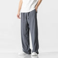 Men's beige bamboo fibre straight-leg cropped trousers with a drawstring waist on a neutral background.