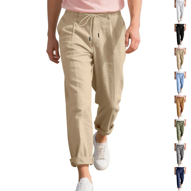 Man wearing light khaki straight-leg linen trousers with a drawstring waist.