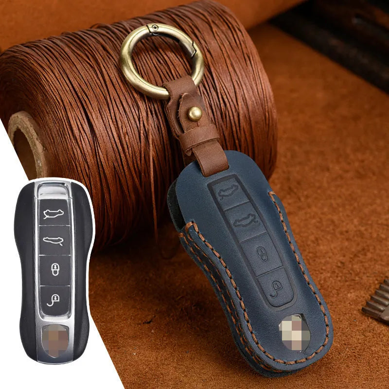 Brown leather Porsche key case with a metal buckle closure.
