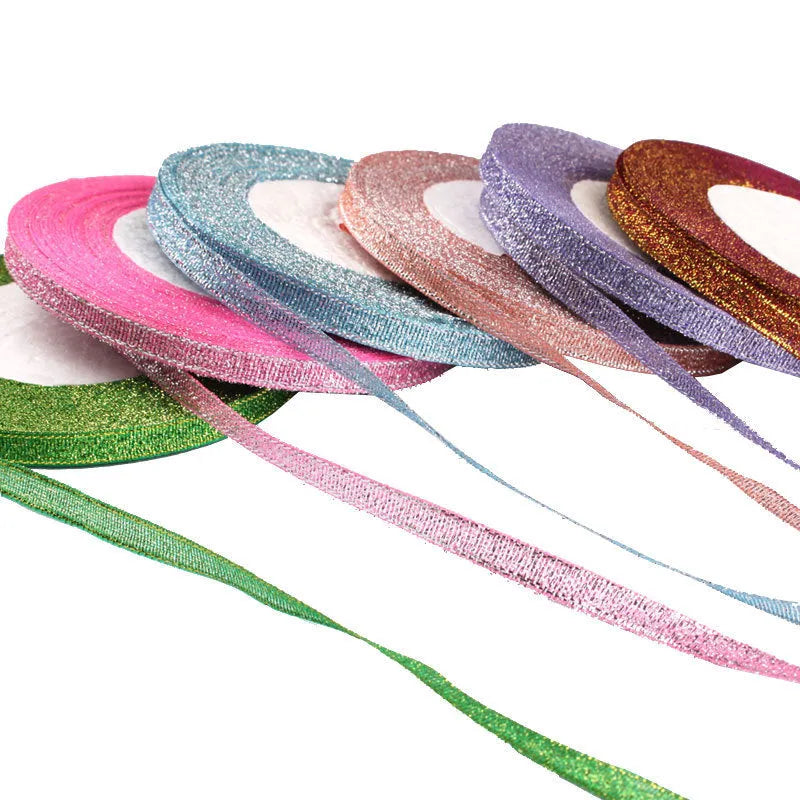 Roll of 0.6cm wide coloured polyester ribbon in onion-dye shades for clothing and gift packaging