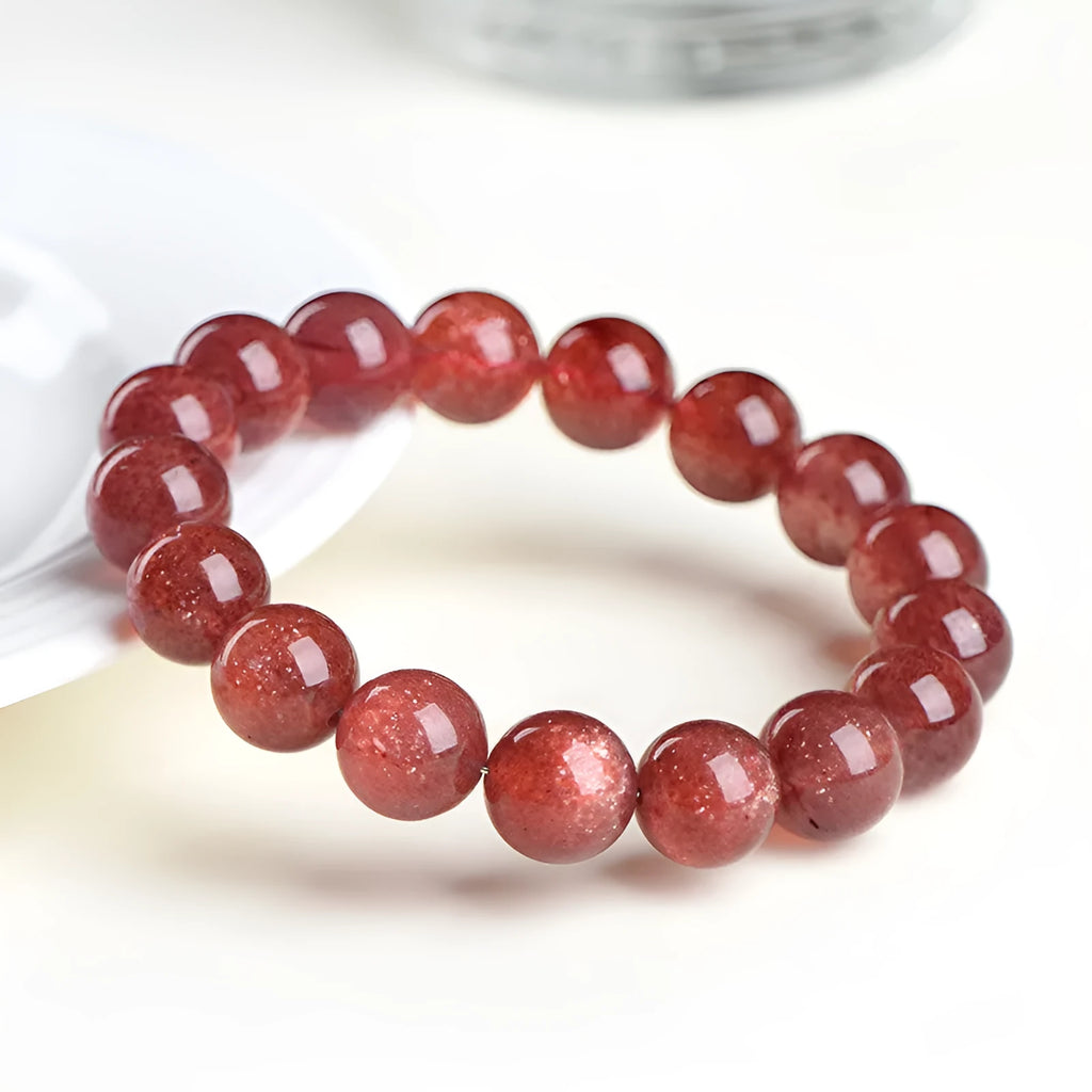 Polished cherry red strawberry quartz geometric bracelet on a white background, showing 3A and 5A grade options.