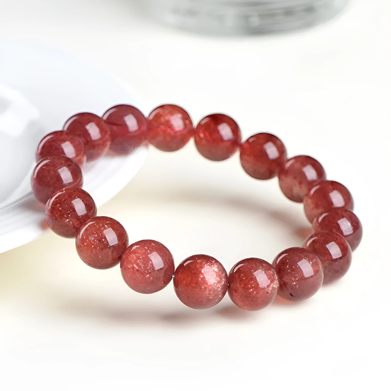 Polished cherry red strawberry quartz geometric bracelet on a white background, showing 3A and 5A grade options.