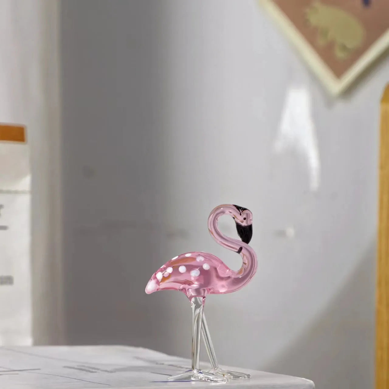 Pink crystal flamingo decorative animal figure on table with modern minimalist style